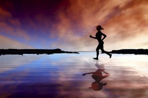 runner on beach at sunset